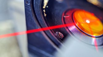 Red laser on optical table in physics laboratory