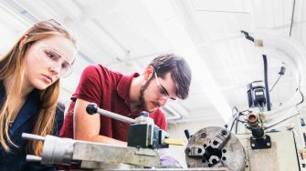 Engineers working on a heavy machinery for their project work