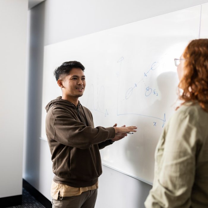 uDASH Student discussing Data Science on whiteboard - Hakiim Jamaluddin