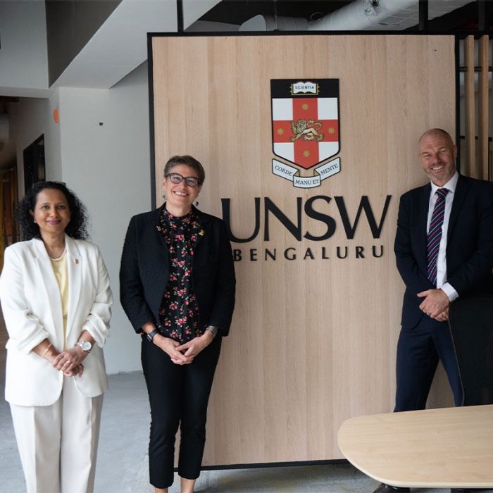 unsw staff group photo in front of unsw bengaluru logo