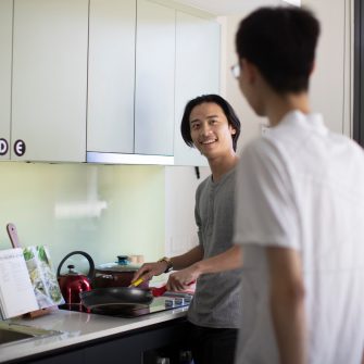 Students cooking in kitchen of student accommodation