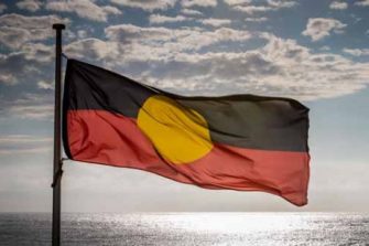 Aboriginal flag flying over the ocean