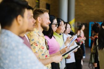 Group of diverse students performing as a choir