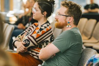 An audience watches a Diversity Festival presentation