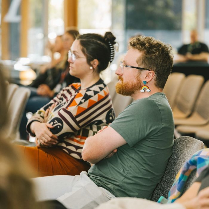 An audience watches a Diversity Festival presentation