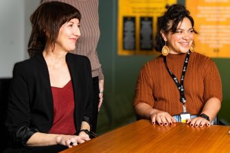 Ruth McCausland and Peta MacGillivray smiling at something off camera