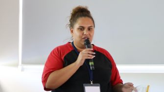 Zoe Sands speaking at a conference