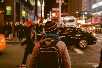 Person crossing highway during nighttime