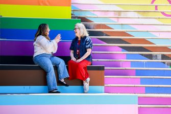People chatting on colourful steps