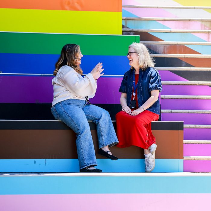 People chatting on colourful steps