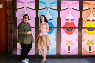 People having a laugh in front of a colourful outdoor space