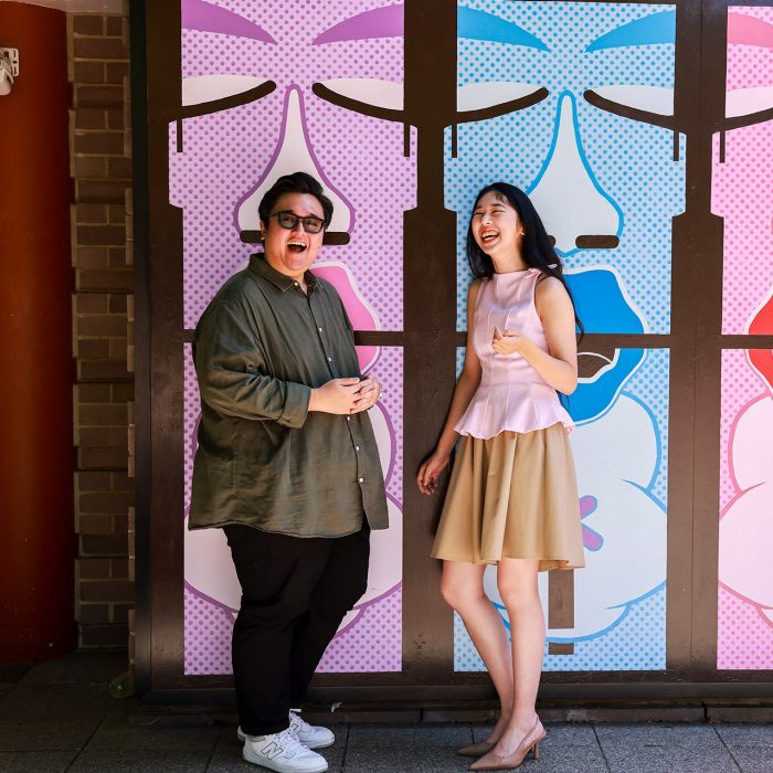 People having a laugh in front of a colourful outdoor space