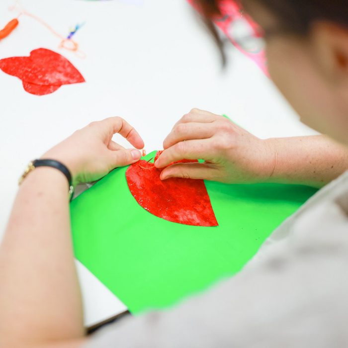 A person creating colourful artwork