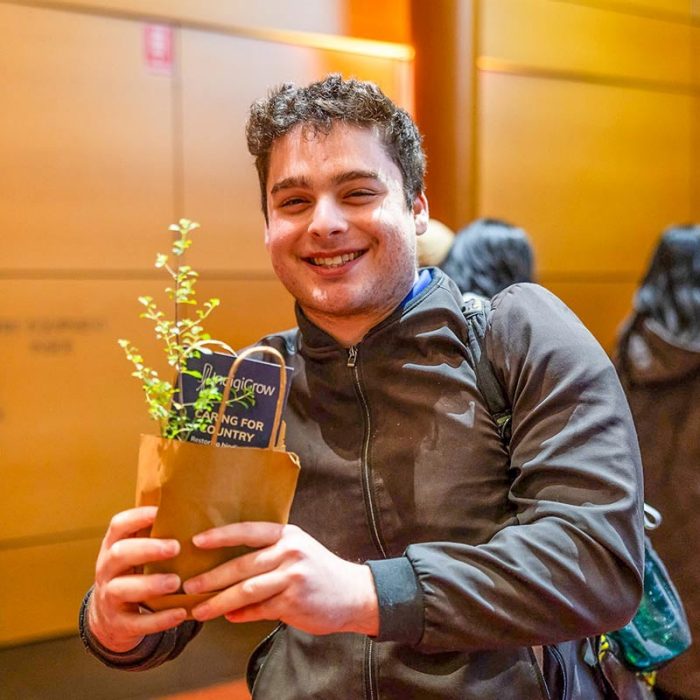A smiling attendee holds a small potted plant at UNSW Employability’s Careers with Impact 2026.