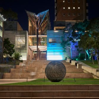 UNSW Kensington campus with coloured lighting to acknowlegde Naidoc week.