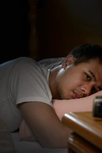 Peerson suffering from insomnia lying in bed