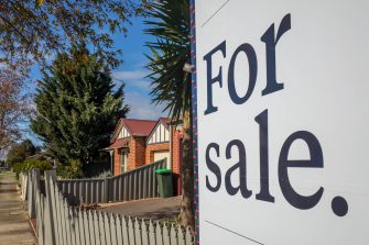 A for sale sign in a suburban street