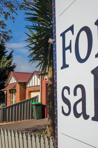 A for sale sign in a suburban street