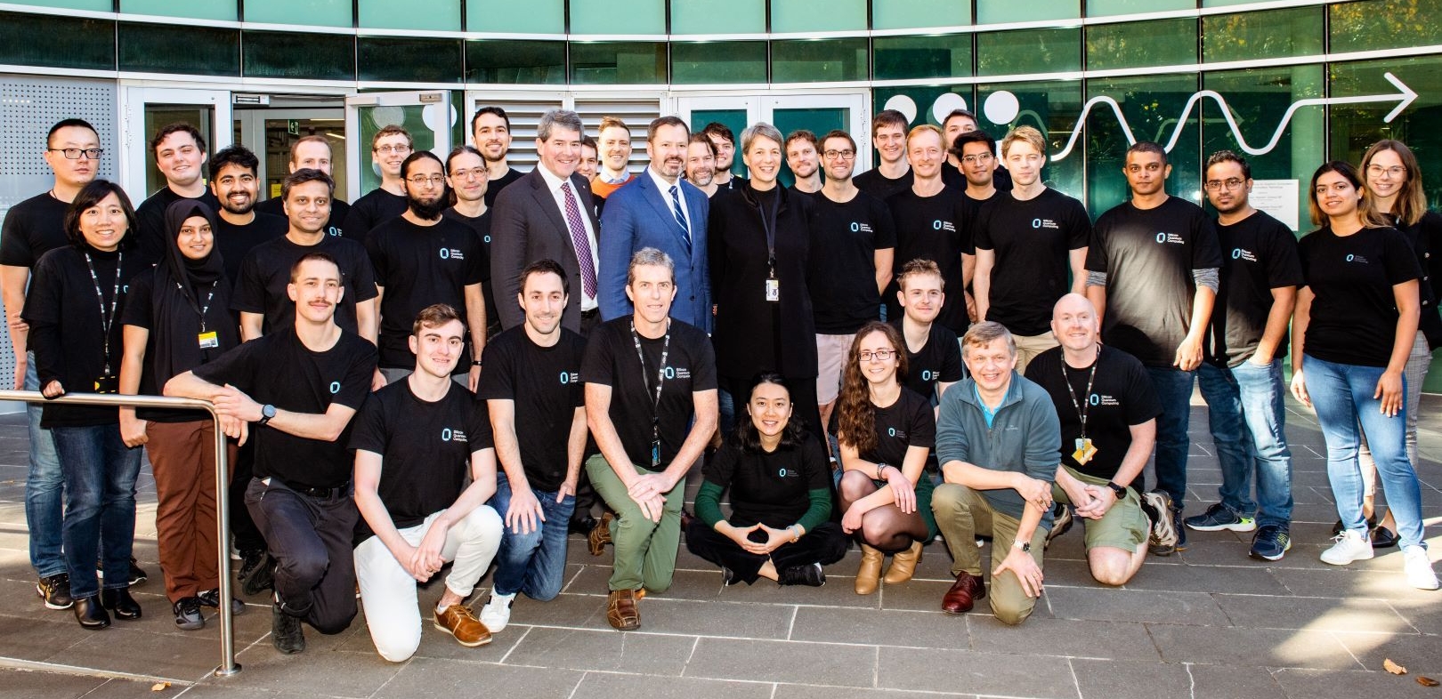 The Silicon Quantum Computing (SQC) team with the Minister for Industry and Science, Ed Husic (centre in navy suit) during the visit. To Mr Husic's left is UNSW Scientia Professor and lead researcher at Silicon Quantum Computing, Michelle Simmons. To Mr Husic's right is Dr Peter Yates, Chairman of the Australian Research Council Centre of Excellence for Quantum Computation and Communication Technology at UNSW.