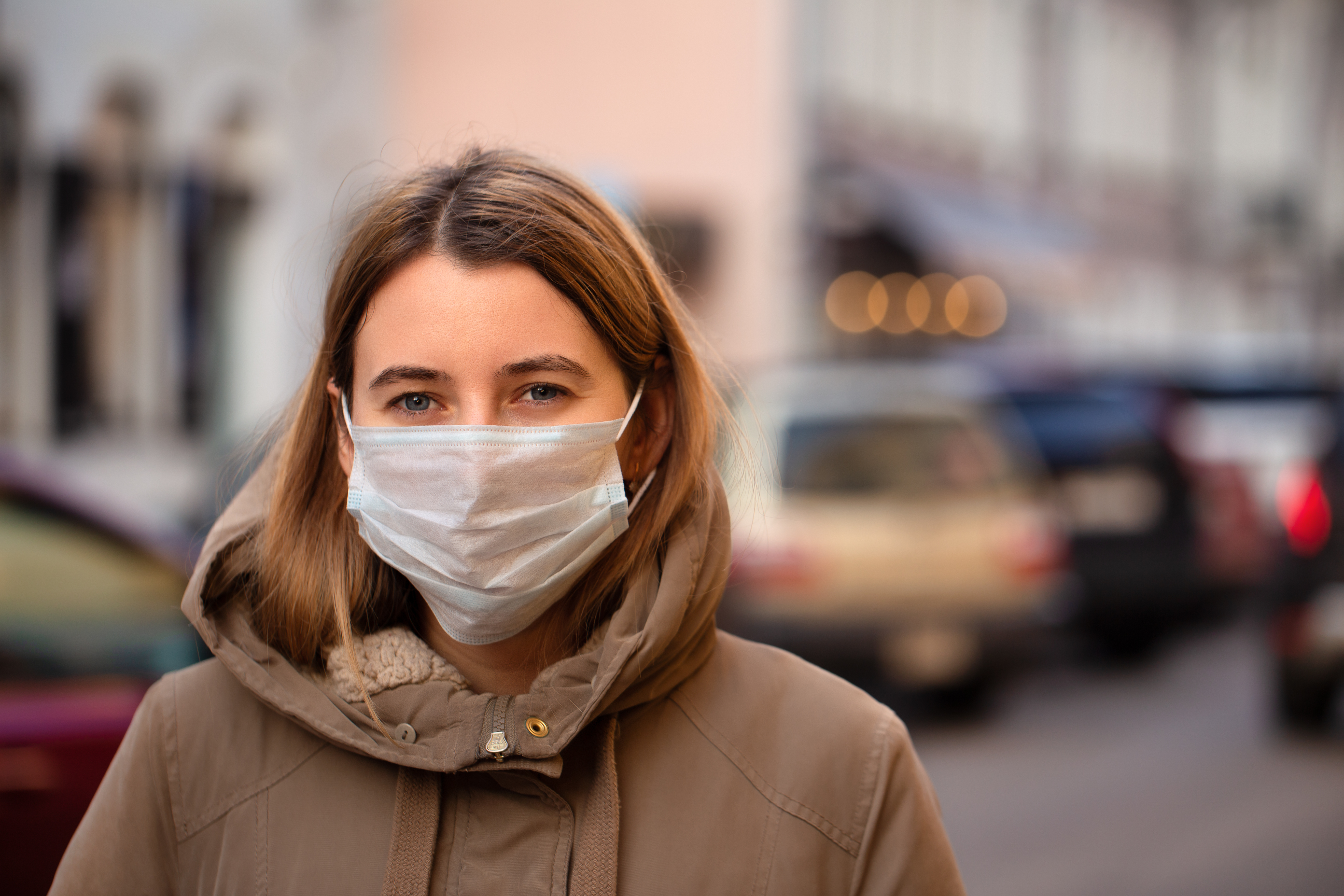 Woman wearing a face mask and jacket