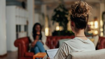 Woman counsellor talks to client in therapy session