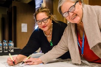 Megan David and Pat Anderson signing