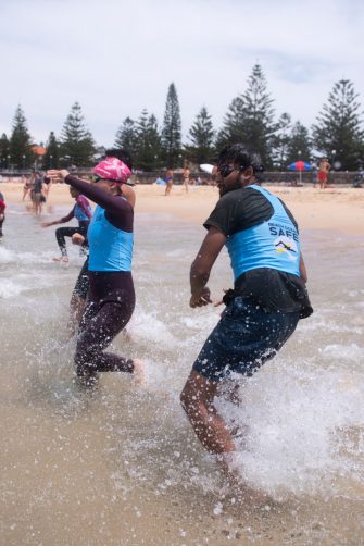 Group of young people in the waves at the beach