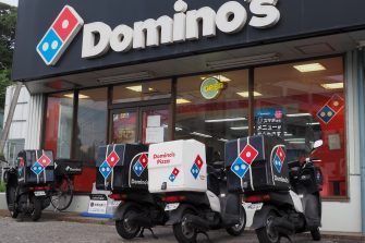 CHIBA, JAPAN - August 18, 2025: Domino's Pizza restaurant with delivery scooters in front of it in Chiba City.