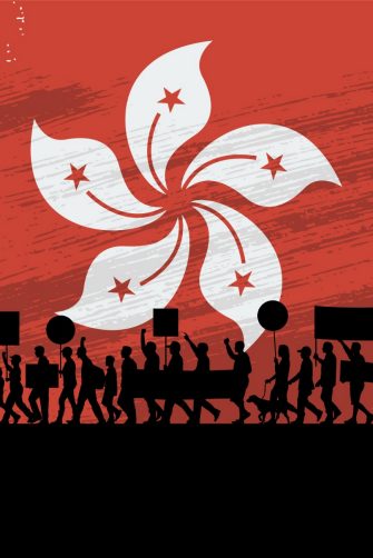 Silhouette of people protesting with a flag of Hong Kong as a background