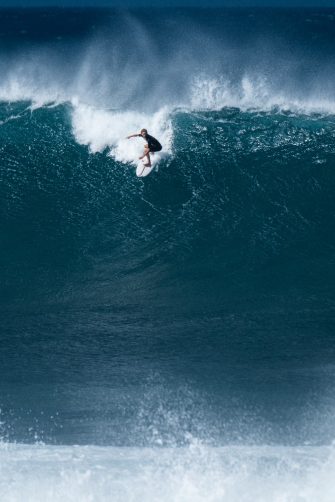 Surfer rides giant wave at the famous Banzai Pipeline surf spot located on the North Shore of Oahu in Hawaii