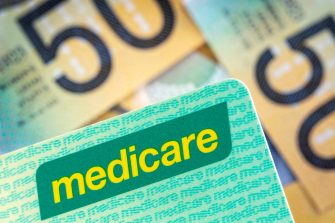 Australian Medicare card over blurred money background.