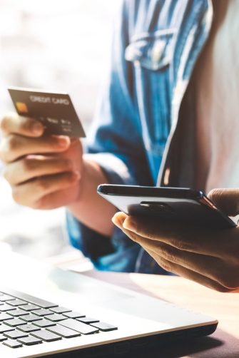 Men use their credit cards through mobile internet banking apps to shop online and digital payment ideas.