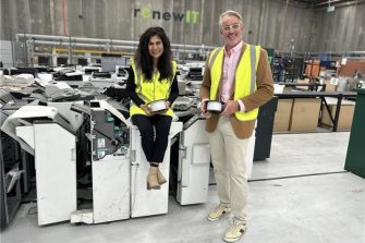 A woman and man standing inside a printer factory.