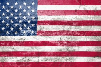 US State Flag. Dirty American state flag on the wall. Grunge wall texture 