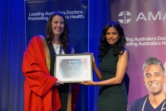 A woman being presented with an award.