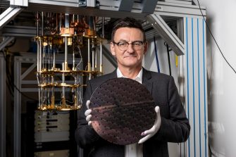 Andrew Dzurak of Diraq holding a 300 mm silicon wafer, which was fabricated at imec according to Diraq's design.