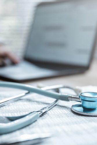 Health insurance concept. Healthcare and medical care. Life insurance policy. Medicine, Hospital, Stethoscope, Doctor. Patient business. Healthcare expense. A person is typing with a stethoscope.