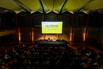 Nila Ibrahimi and Vice-President Societal Impact, Equity and Engagement Prof. Verity Firth on stage at the UNSW Gandhi Oration