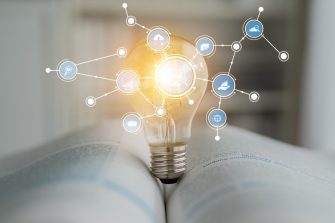 A striking image of a light bulb representing innovation is set on an open book, showcasing the fusion of technology and knowledge with various connected icons. Tessel