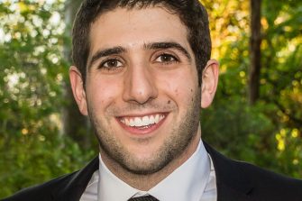 A headshot of a man in a suit