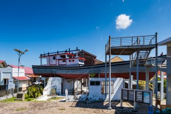 Banda Aceh, Indonesia - 12.26.2024: Aceh 2004 Tsunami monument, a ship on the roof of the house in Banda Aceh, Sumatra, Indonesia