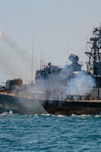 A warship firing missiles.