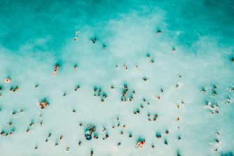Aerial Summer View Of Clear Ocean Water Full Of Tourists
