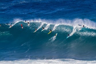 A surfer or swimmer has a close call with an out of control surfboard