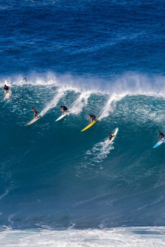 A surfer or swimmer has a close call with an out of control surfboard