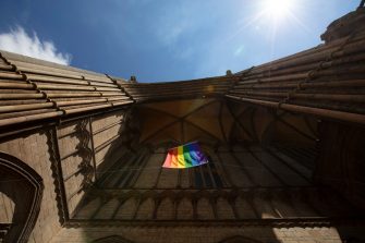 Peterborough, Cambridgeshire, United Kingdom, July 2019, A view of a Pride flag hanging from Peterborough Cathedral