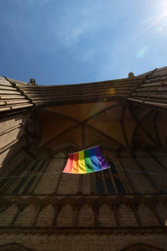 Peterborough, Cambridgeshire, United Kingdom, July 2019, A view of a Pride flag hanging from Peterborough Cathedral