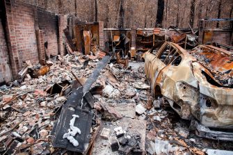 A car and house in ruins after a bushfire in Australia