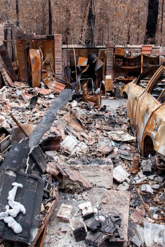 A car and house in ruins after a bushfire in Australia