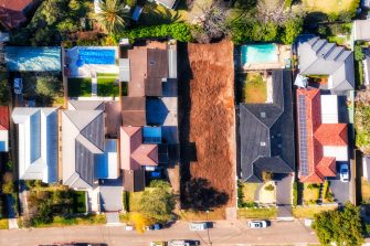 Demolished home building construction site in residential suburb of City of Ryde in Sydney West - aerial top down view.
